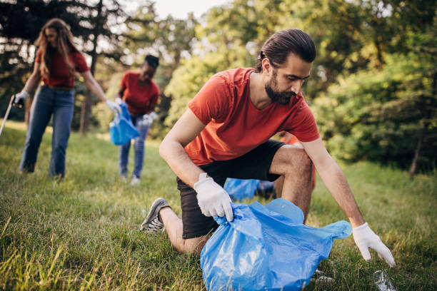 istock Male volunteer cleaning nature 1691339485