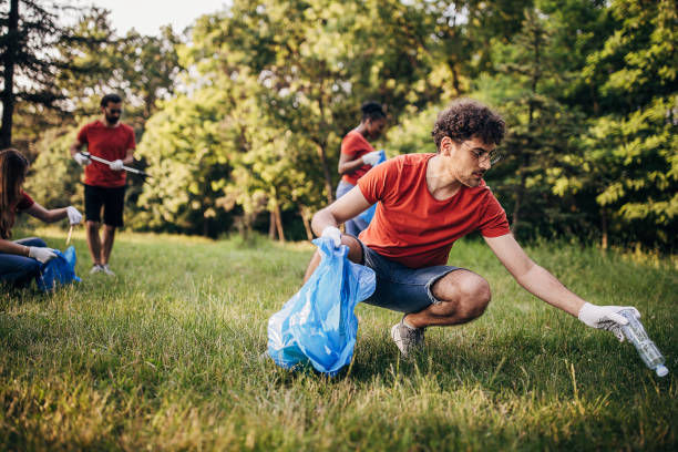 istock Male volunteer cleaning nature 1691347825