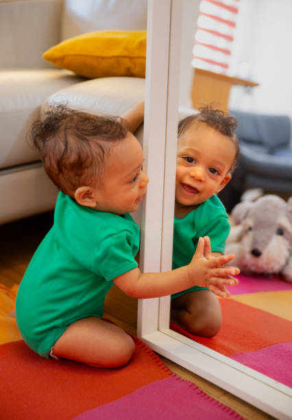 istock Eight months old baby playing with mirror 1691369594