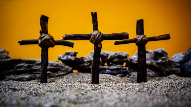 istock crosses stuck in the sand on an orange background 1691388657