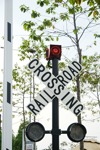 Selective focus picture of railroad crossing sign at tram railway in the morning