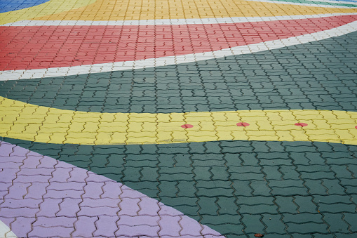 A close up picture of colourful crosswalk road during daytime.