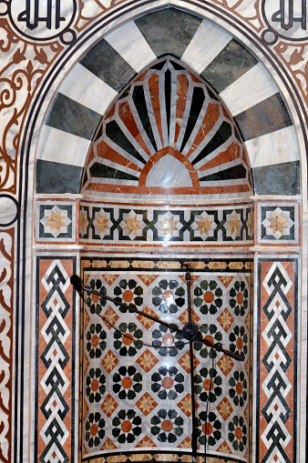 A Mosque Mihrab, a niche in the wall of a mosque that indicates the qibla, the direction of the Kaaba in Mecca towards which Muslims should face when praying, The qibla wall inside a grand mosque, selective focus