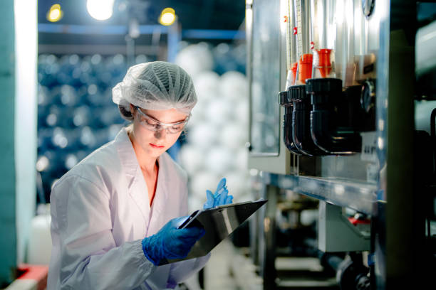istock scientist worker checking the quality of Reverse osmosis machine system at the industrial factory. Female worker recording data at the control panel with measure pressure for recycle portable plant. 1691408756