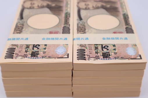Close-up photo of a large number of Japanese 10,000 yen bills