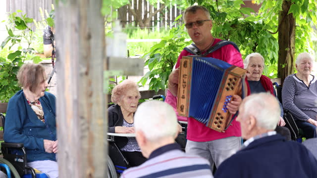 Nursing Home outdoor party with Harmonica musing and singing
