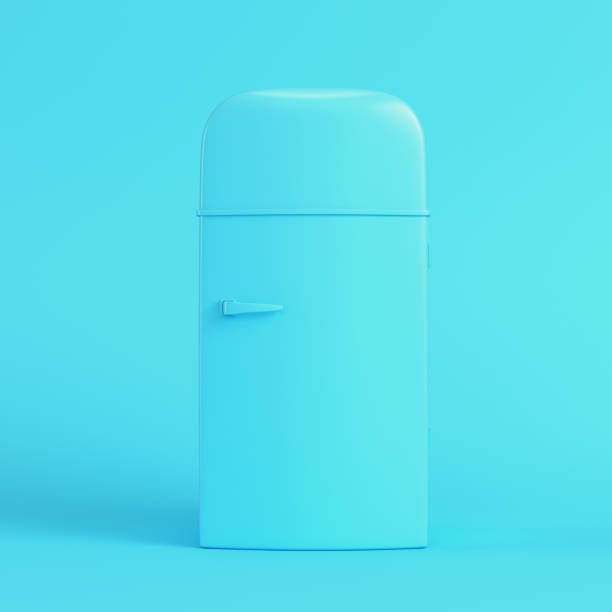 Old styled fridge on bright blue background in pastel colors stock photo