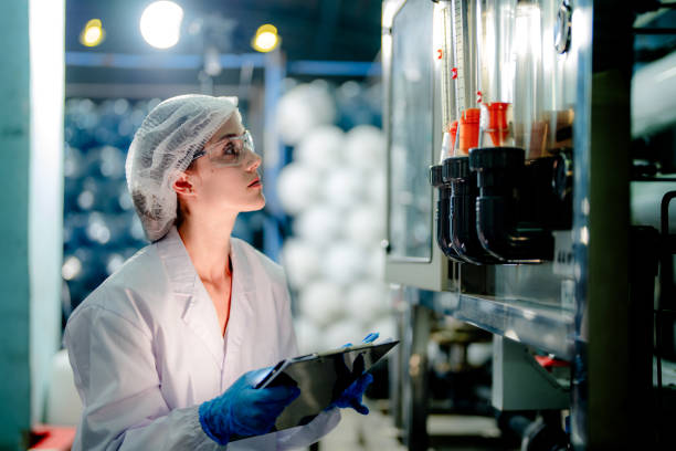 istock scientist worker checking the quality of Reverse osmosis machine system at the industrial factory. Female worker recording data at the control panel with measure pressure for recycle portable plant. 1691432281