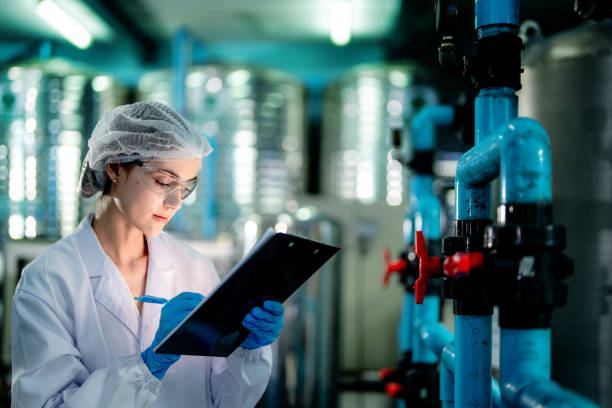 istock scientist worker checking the quality of Reverse osmosis machine system at the industrial factory. Female worker recording data at the control panel with measure pressure for recycle portable plant. 1691434453