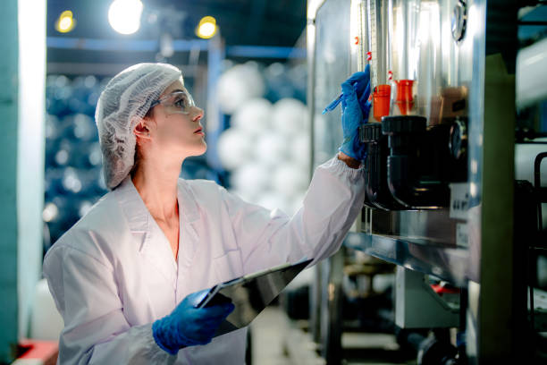 istock scientist worker checking the quality of Reverse osmosis machine system at the industrial factory. Female worker recording data at the control panel with measure pressure for recycle portable plant. 1691434472