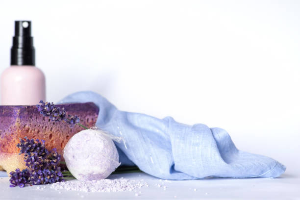 Natural cosmetics. Handmade bath bomb, lavender essential salt and body lotion with lavender flowers. Purple ball sea salt and lotion for spa treatments and body care and essential salt for aromatherapy and relaxation
