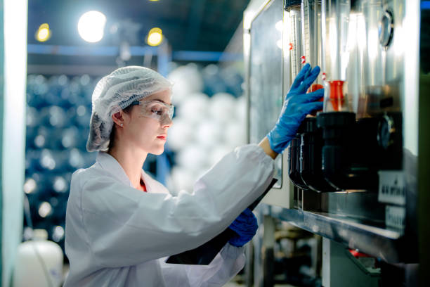 istock scientist worker checking the quality of Reverse osmosis machine system at the industrial factory. Female worker recording data at the control panel with measure pressure for recycle portable plant. 1691434990