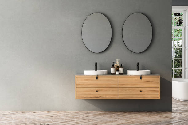 istock Modern bathroom interior with double sink and mirror, bathtub, plants. Bathing accessories and window in hotel studio. 1691459324