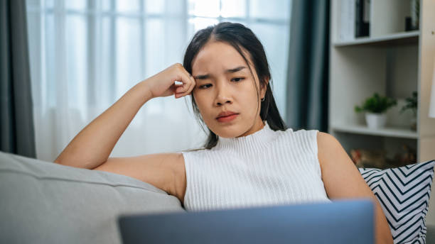 istock Young woman has her money stolen while using laptop computer online fraud 1691471604
