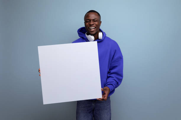istock positive young african man with a mockup for advertising on the background with copy space 1691475721
