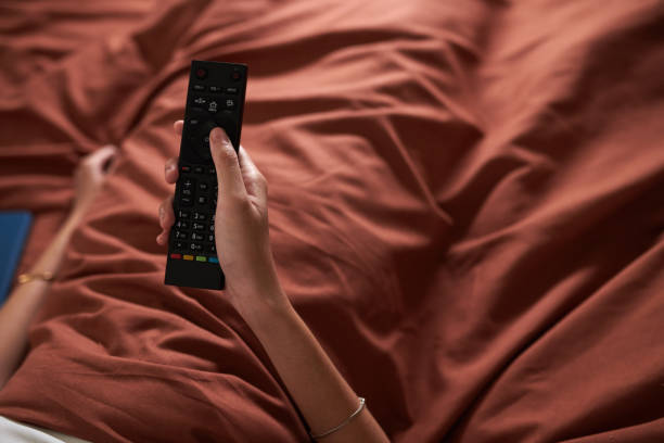 istock Woman Switching TV Channels 1691485390