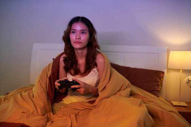 istock Girl Playing Videogame at Night 1691485392