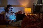 Woman Working on Laptop Late at Night