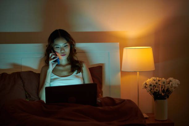 istock Young Woman Working in Bed 1691485420