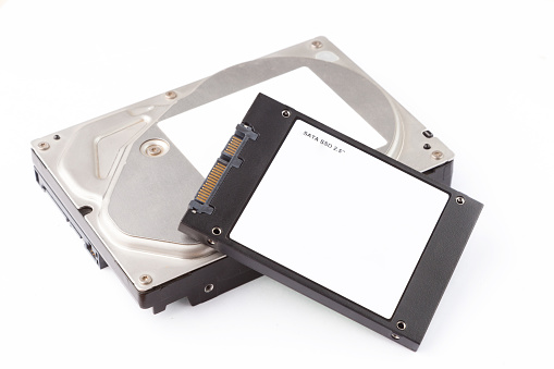 hard disks and solid state SATA drives on the white background, HDD vs SSD