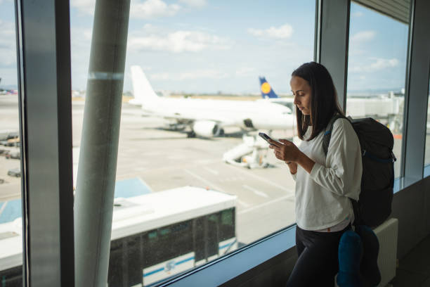istock Woman using smartphone at the airport 1691528456