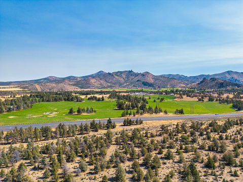 An aerial view of Green pastures and Mountains in the distance. Desert area of Central Oregon.