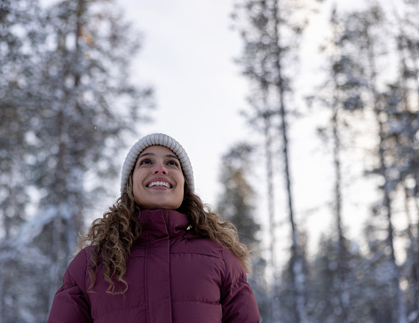Portrait of a happy woman outdoors enjoying the winter in Finland - lifestyle concepts