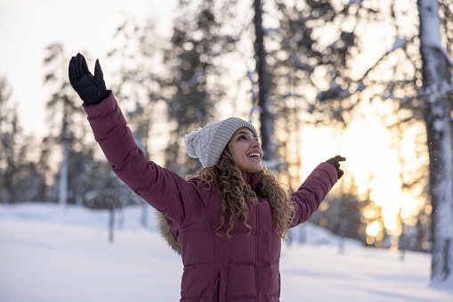 Woman enjoying the winter outdoors and looking very happy