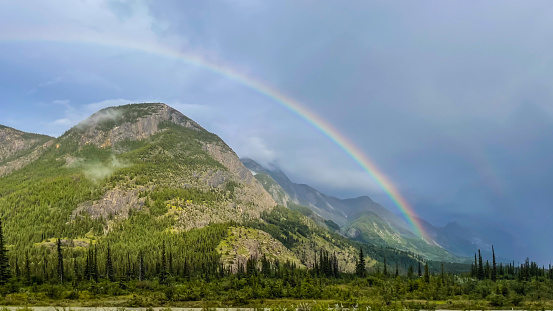 Rainbow over mountain in Jasper National Park in Canada. in Jasper, Alberta, Canada