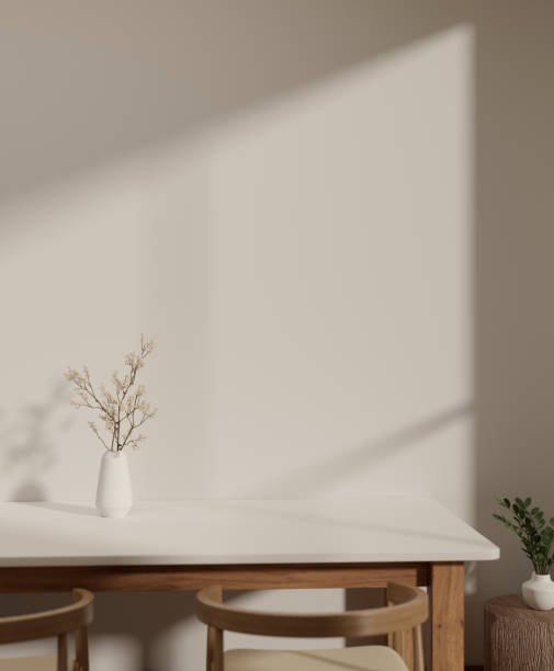 istock Empty space on a minimal white table against the white wall and minimal wooden armchairs in a room. 1691558084