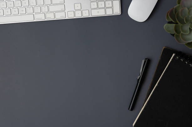 istock Top view of a modern dark grey workspace with accessories and a copy space. 1691558102