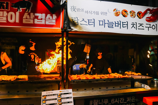 Jeju Island, South Korea - July 11, 2022: Korean street food at Dongmun night market, the famous street food area were crowd with many tourist from around the world.
