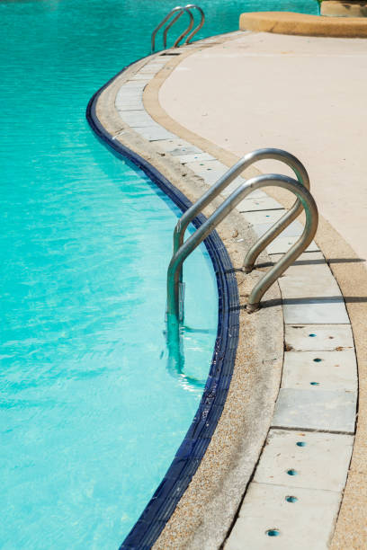 istock Swimming pool edge with ladder in home 1691637273