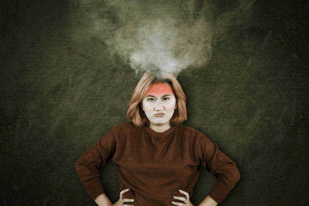 istock Angry Asian woman with smoking head looking at camera 1691678289