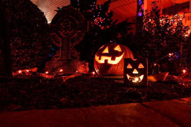 istock Brightly Illuminated Grinning Jack O' Lanterns on Dark Halloween Night 1691693405