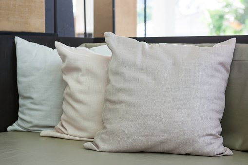 Sofa with pillows in room at home.