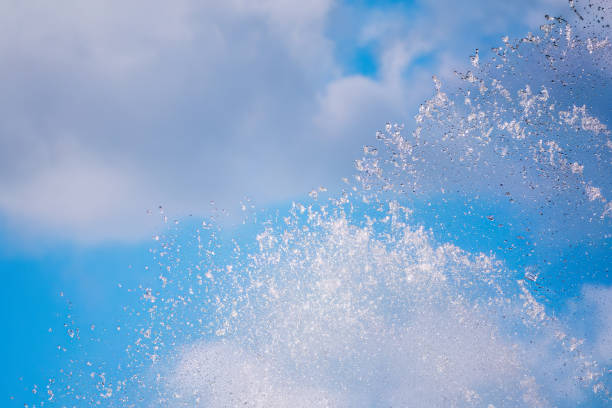 istock Splashes of water against the blue sky background 1691711016