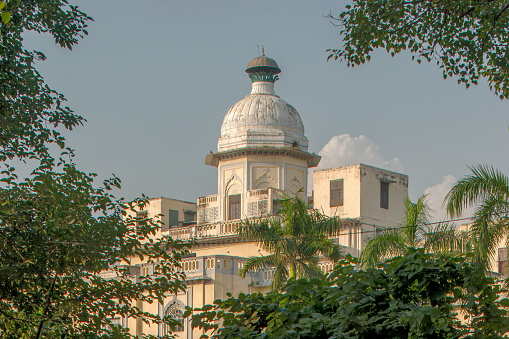 street lamp in classical style in the daytime over the blue sky and trees background