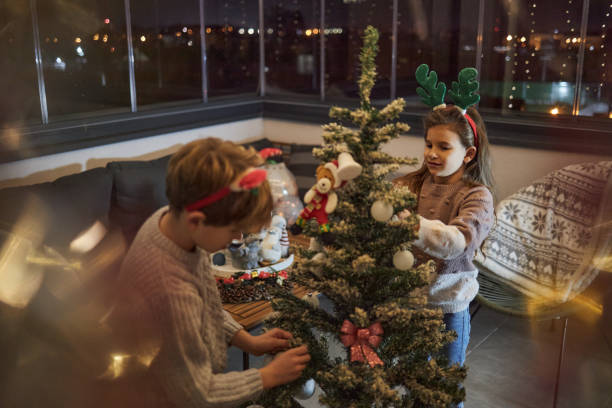 istock Happy children decorating Christmas Tree 1691725132