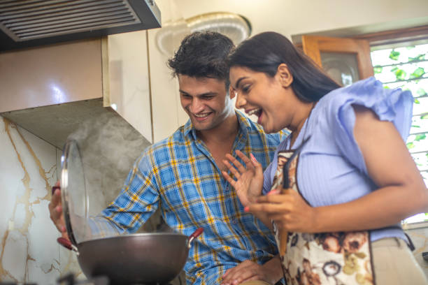 istock Cheerful young couple cooking together in kitchen 1691732866