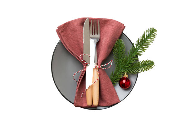 istock isolated christmas Plate with decor and fork and spoon. New year holiday background. Top view 1691758663