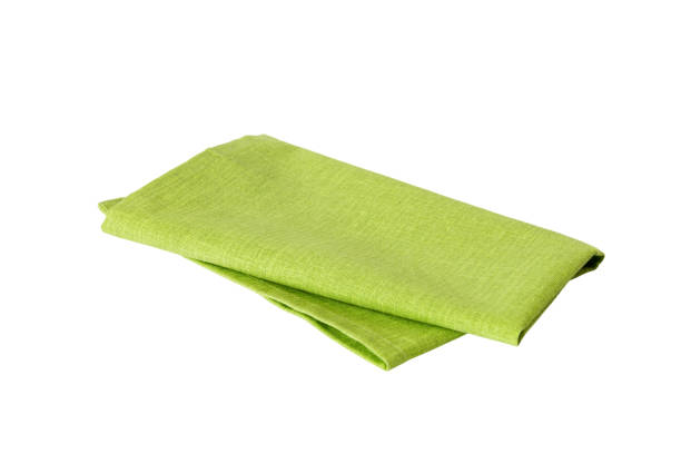 istock Green textile napkin isolated on white background. Folded decorative kitchen cotton towel. Top view 1691759260