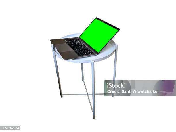 Laptop With Green Screen On White Round Table Isolated On White Background Stock Photo - Download Image Now
