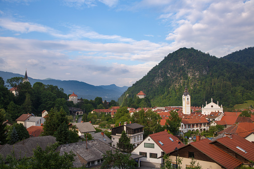 Postcard view of old town Kamnik in Slovenia with churches, castles, train station and more.