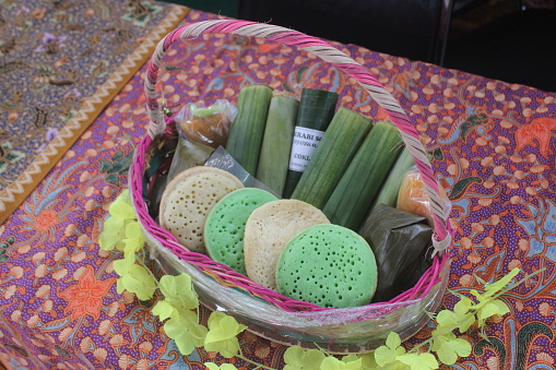 A photo of traditional food on a batik cloth as the background.