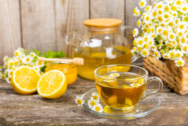 istock Chamomile tea in  cup on  texture background. Natural hour with chamomile flowers. Herbal tea. Immunity tea.Natural healer concept. Healthy detox drink.Close up. Place for text. 1691763788