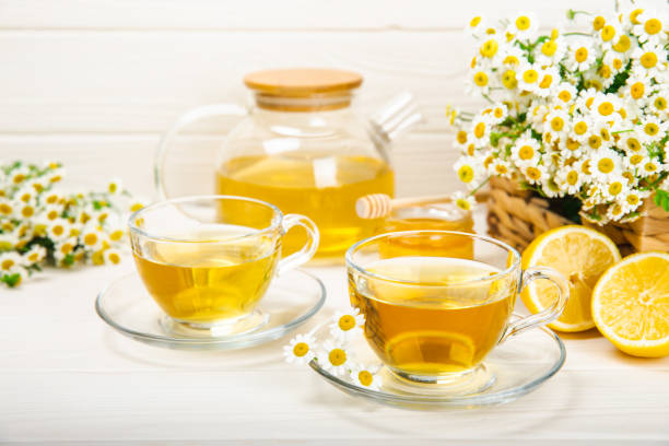 istock Chamomile tea in  cup on  texture background. Natural hour with chamomile flowers. Herbal tea. Immunity tea.Natural healer concept. Healthy detox drink.Close up. Place for text. 1691771154