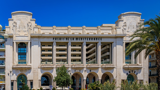 Nice, France - May 30, 2023: The famous Palais de la Mediterranee Art Deco hotel and casino by Hyatt and palm trees on the Promenade des Anglais