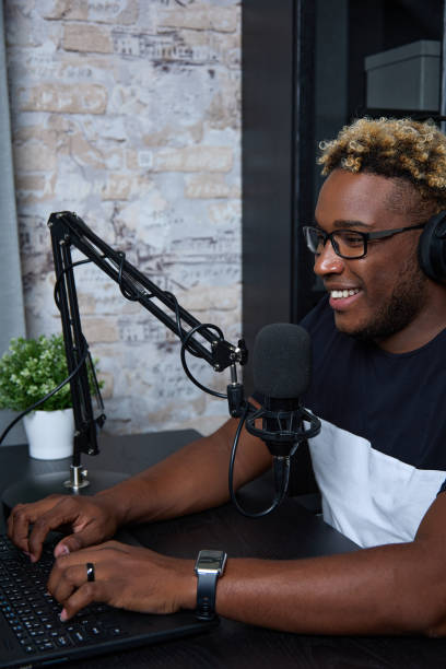 istock Joyful black radio presenter in a modern loft-style studio hosts the program 1691783250