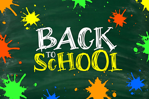 Chalkboard with BACK TO SCHOOL lettering and multi colored ink blobs. Blackboard with chalk traces and smudges.